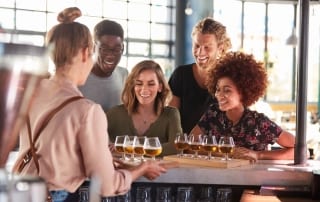 A photo of a group enjoying a beer flight at a Naples brewery.