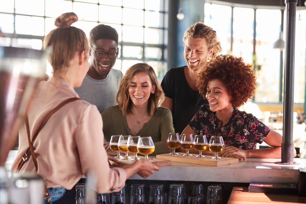 A photo of a group enjoying a beer flight at a Naples brewery.