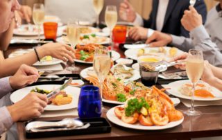 A photo of a group eating at one of the best Naples seafood restaurants.