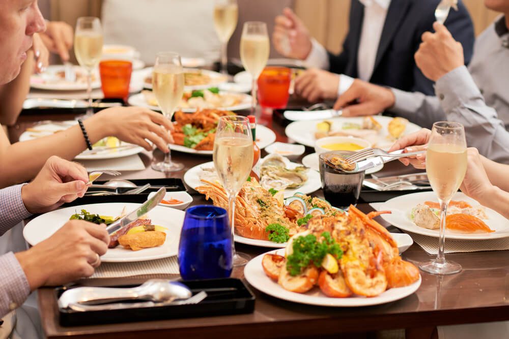 A photo of a group eating at one of the best Naples seafood restaurants.