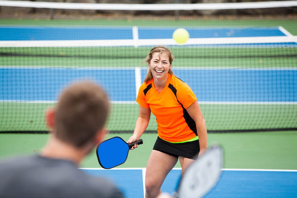 Two people playing pickleball during one of the annual Naples events.