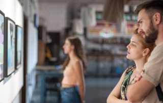 A couple looking at art in a Naples gallery.