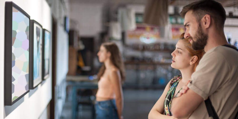 A couple looking at art in a Naples gallery.