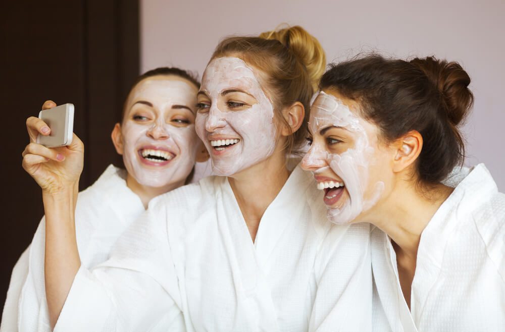 A group of women taking photos while at a Naples spa.