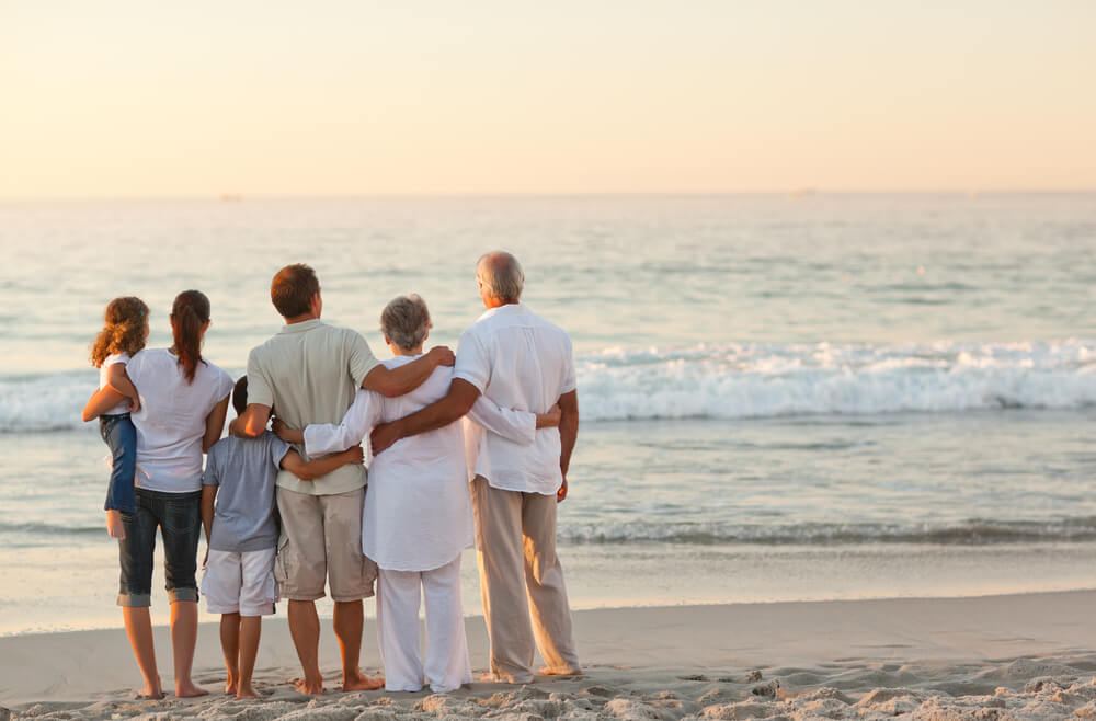 A family standing on the beach during a winter vacation to Vanderbilt Beach, Naples, in Florida.