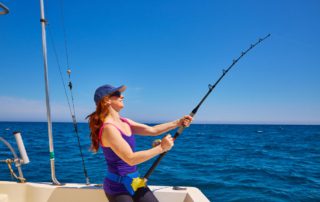 A woman deep sea fishing in Naples.