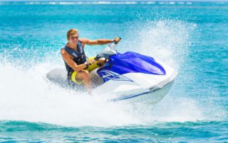 A person riding a jet ski in Naples, one of the best water activities in Florida.