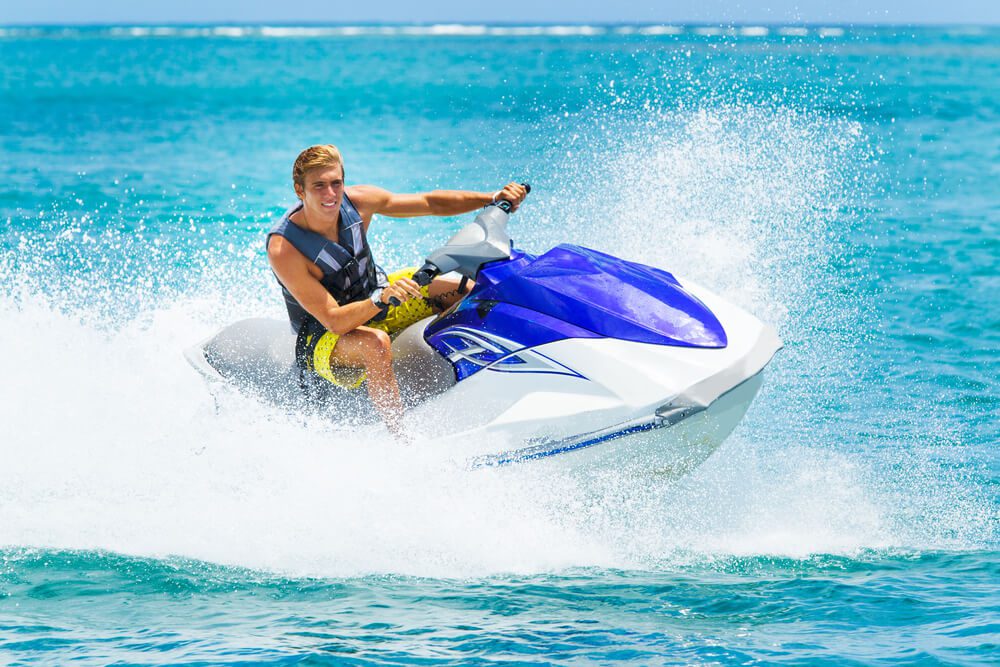 A person riding a jet ski in Naples, one of the best water activities in Florida.