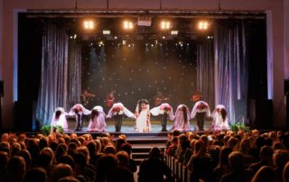 A group of performers on stage at one of the live entertainment venues in Naples, Florida.