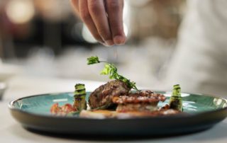 A chef plating a dish at one of the best restaurants in Naples, Florida.