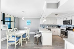 A dining and kitchen area of a vacation rental to enjoy takeout from the best places to eat in Naples.