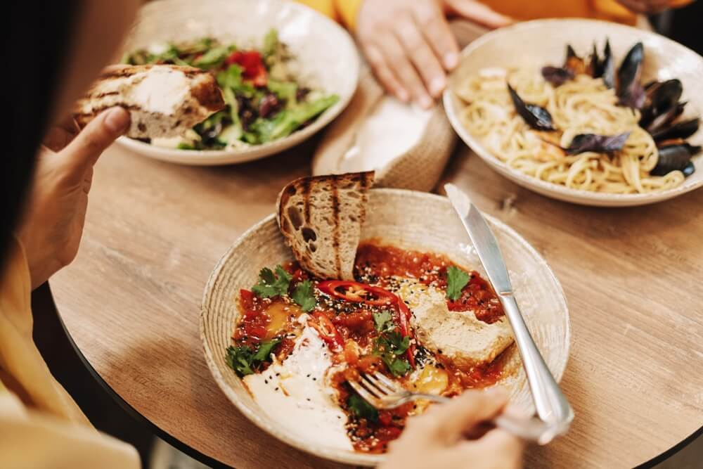 A person eating at one of the best places to eat in Naples.