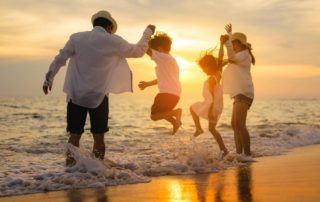 A family playing in the surf at one of the beaches in Naples.