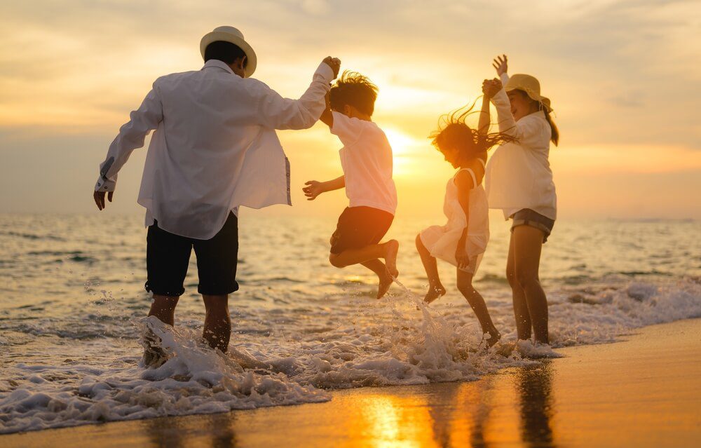 A family playing in the surf at one of the beaches in Naples.