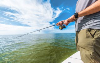A person fishing on a trip in Naples, FL.
